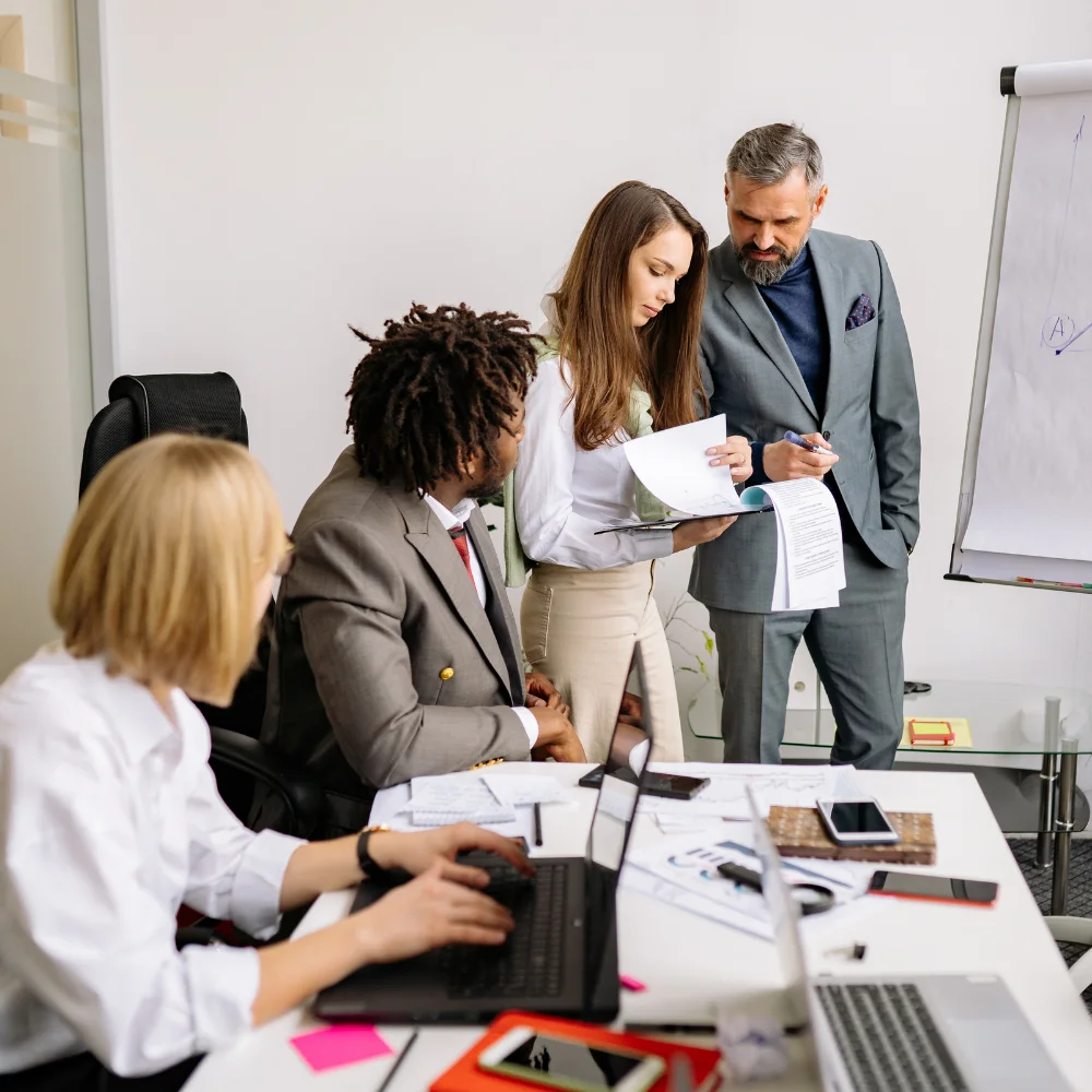 Business team reviewing company registration documents in a modern office