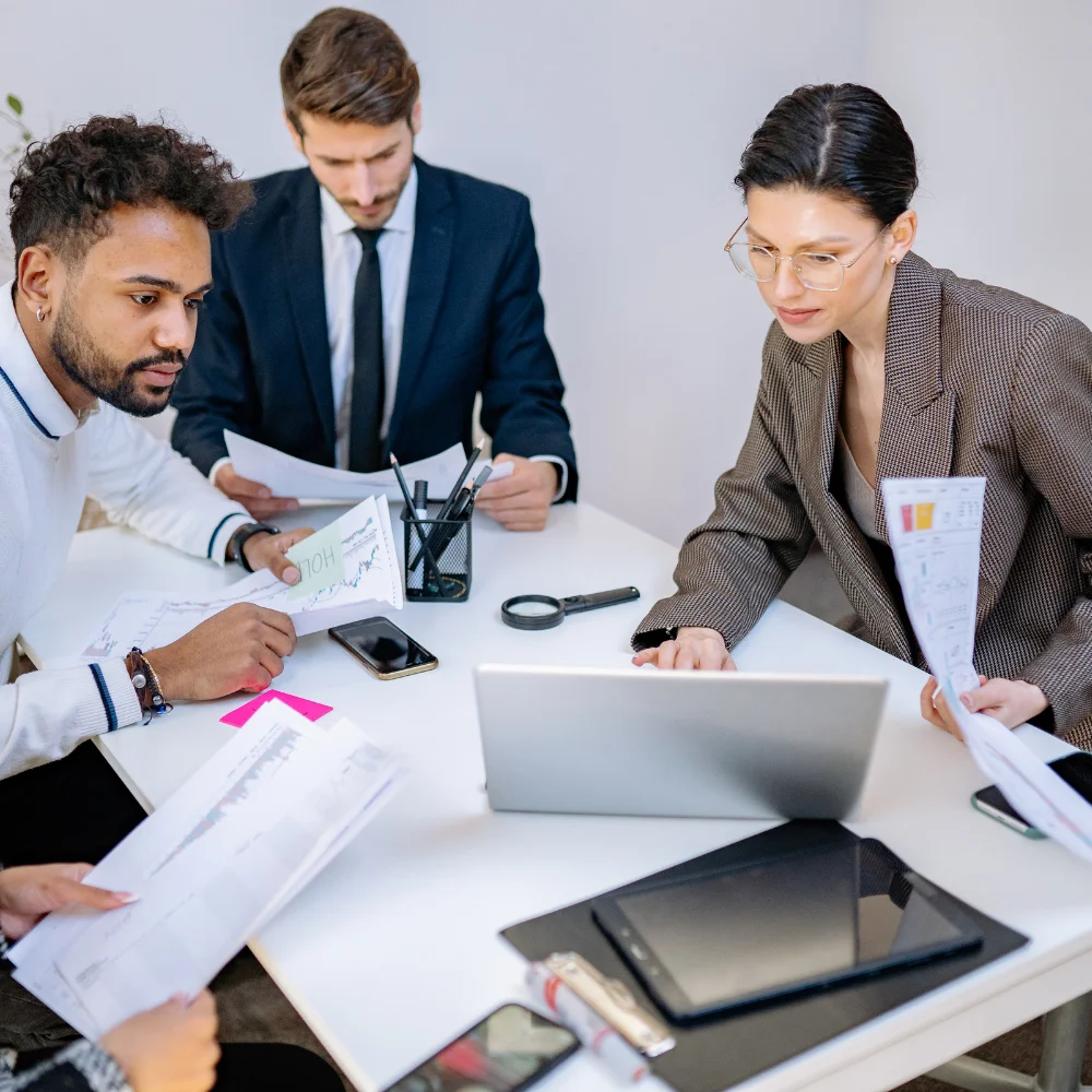 Business team reviewing company registration documents in a modern office